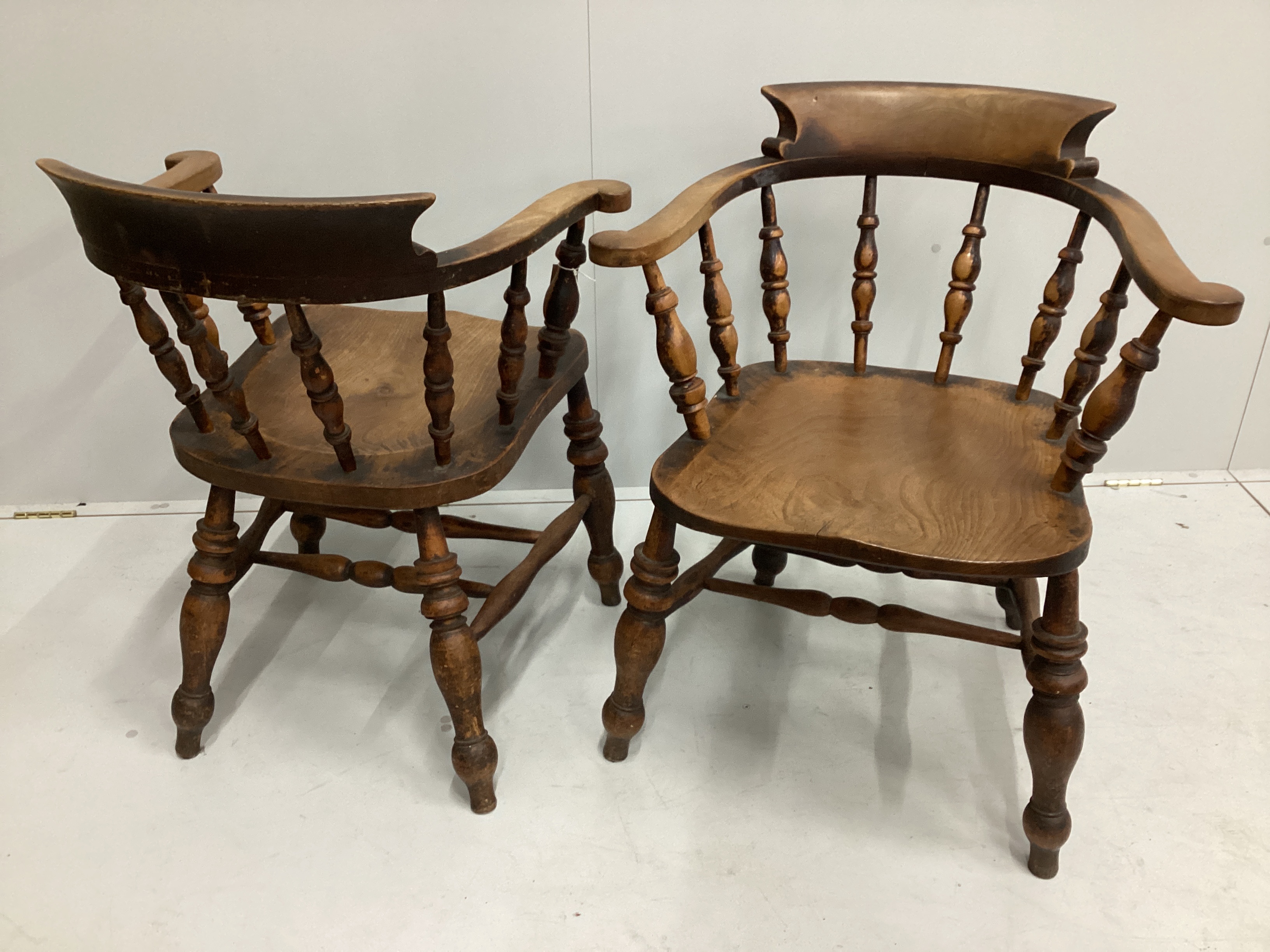 A pair of Victorian elm and beech smoker's bow elbow chairs, width 67cm, depth 50cm, height 82cm